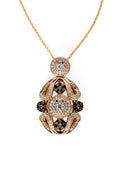 The 14K Yellow Gold Diamond Filigree Pendant features ornate scrollwork with white and dark diamonds totaling 1.04 TCW, all set in luminous yellow gold against a white background.