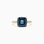 The Ocean Bleu 14K yellow gold ring boasts a cushion-cut London Blue Topaz centerpiece and sparkling round diamonds along the band, totaling 4.54 TCW.