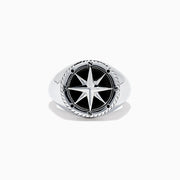 The Mens Sterling Silver Onyx Compass Ring, 2.61 TCW, features a raised compass rose with black enamel and engraved cardinal directions on a plain white background, creating a bold statement piece.
