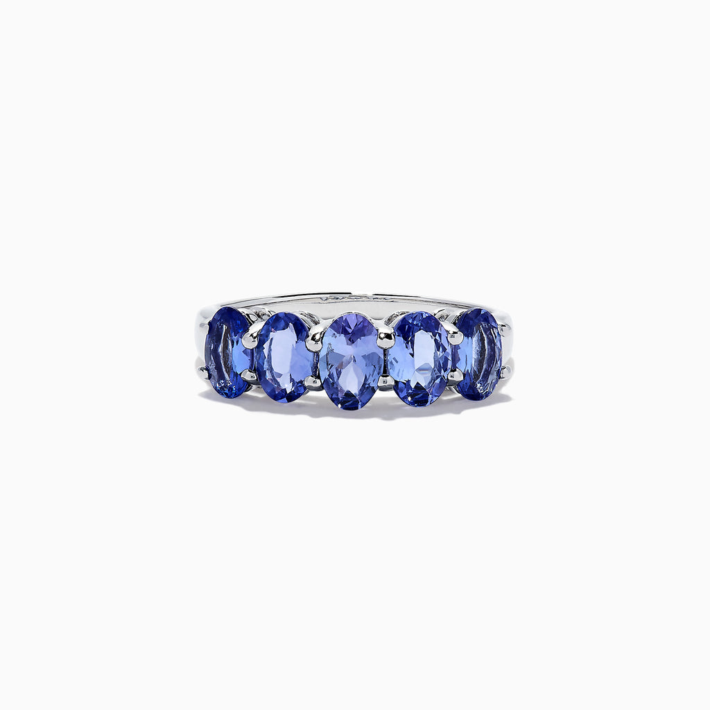 The Nahla Siri Sterling Silver Tanzanite Band Ring, 2.14 TCW, features five oval tanzanite gemstones in a row, each secured by four prongs and showcased against a white background.
