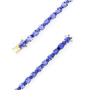 The Sterling Silver with 14K Gold Lock Tanzanite Tennis Bracelet, 20.00 TCW, features a row of sparkling tanzanites and a gold-accented clasp, beautifully displayed against a white background.