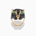 The Collectors Edition 14K Yellow Gold Black Diamond Ring, 3.80 TCW, features a panther head design with black diamonds and vivid green eyes, elegantly showcased against a plain white background.