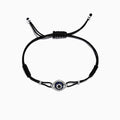 A 14K gold string bracelet featuring a sapphire and diamond evil eye charm (0.56 TW), inspired by the classic motif.