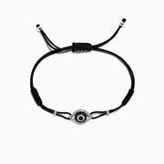 A 14K gold string bracelet featuring a sapphire and diamond evil eye charm (0.56 TW), inspired by the classic motif.