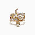 The Safari 14K Yellow Gold Diamond Snake Ring, 0.95 TCW, is shaped like a coiled serpent with white and baguette-cut diamonds and green gemstone eyes, shown on a white background.