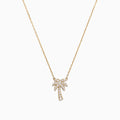 A delicate Novelty 14K Yellow Gold Diamond Palm Tree Necklace, 0.23 TCW, features a small palm tree pendant adorned with sparkling diamonds.
