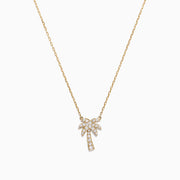 A delicate Novelty 14K Yellow Gold Diamond Palm Tree Necklace, 0.23 TCW, features a small palm tree pendant adorned with sparkling diamonds.