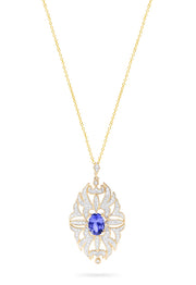 The 14K Yellow Gold Tanzanite and Diamond Pendant, 1.57 TCW, features an ornate oval design with a central tanzanite gemstone accented by diamonds, beautifully set in polished 14K yellow gold.