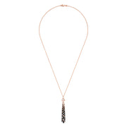 The Confetti 14K Gold Pendant features black, espresso, and white diamonds (1.17 TCW) on a long rose gold chain with a gold pendant accented by geometric details and three black tassels adorned with clear gemstones.