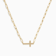 The 14K Yellow Gold West-East Cross Paperclip Chain Necklace 17 features a delicate paperclip chain and a small horizontal cross pendant, all crafted in 14K yellow gold.