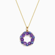 The 14K Yellow Gold Amethyst, Tanzanite, and Diamond Pendant features alternating colorful gemstones in a circular design, hanging elegantly from a delicate gold chain.