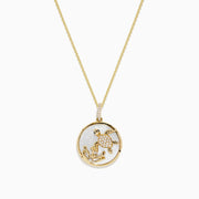 The 14K Yellow Gold Mother of Pearl and Diamond Turtle Pendant (0.13 TCW) features a circular turtle design accented with diamonds, shown against a white background.