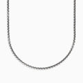 A close-up of the Mens Sterling Silver 21 Box Link Chain shows its sleek box chain design, displayed on a white background and curving gently at the bottom.