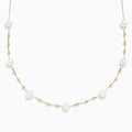 The 14K Yellow Gold 16 Pearl Station Necklace showcases evenly spaced white pearls and gold beads along a delicate chain.