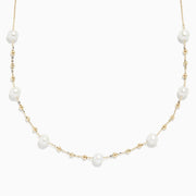 The 14K Yellow Gold 16 Pearl Station Necklace showcases evenly spaced white pearls and gold beads along a delicate chain.