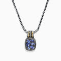 The Nahla Siri Silver & 18K Gold Tanzanite Pendant, 1.85 TCW, features a silver chain and a rectangular pendant with four blue tanzanites set in a decorative frame, accented by 18K gold at the top.
