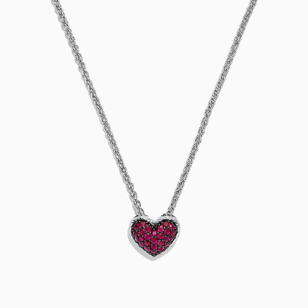 The 925 Sterling Silver Ruby Heart Pendant, 0.65 TCW, is featured on a simple white background, showcasing its ruby heart design with sparkling red gemstones.