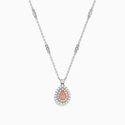 Elegant 18K gold necklace featuring a pinkish-brown certified diamond center, two rows of clear stones, and decorative chain links. Total carat weight: 0.70 TCW.