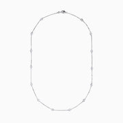 The 14K White Gold 18 Diamond Station Necklace showcases evenly spaced round bezel-set diamonds totaling 1.00 TCW, elegantly displayed against a white background.