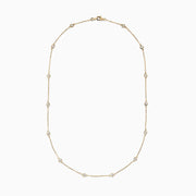 The 14K Yellow Gold 18 Diamond Station Necklace, 1.00 TCW, features small round bezel-set diamonds spaced along a delicate gold chain for an elegant, minimalist look.