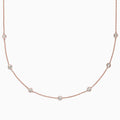 The Pave Rose 14K Rose Gold Diamond Station Necklace, 0.69 TCW, features round bezel-set diamonds spaced along a fine rose gold chain and is displayed on a plain white background.