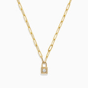 The Novelty 14K Yellow Gold Diamond Mini Lock Necklace features elongated links and a small gold padlock pendant with a central round diamond, displayed on a white background.