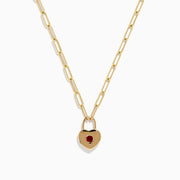 The Ruby Royale 14K Yellow Gold Ruby Heart Lock Necklace features elongated links and a heart-shaped padlock pendant set with a central ruby gemstone.