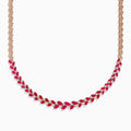 The Ruby Royale 14K Yellow Gold Ruby and Diamond Leaf Necklace showcases a leaf-inspired design with alternating rubies and diamonds in front, smoothly transitioning to a sleek yellow gold pattern at the back.