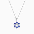 The Nahla Siri 14k Gold Star of David Pendant features tanzanite and diamond accents, displayed on a white background.