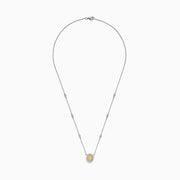 The Canare 14K White Gold Oval Halo Yellow Diamond Pendant Necklace, 0.81 TCW, features a central oval yellow diamond surrounded by clear stones on a silver chain for an elegant, radiant look.