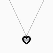 The Novelty 14K White Gold Black Enamel & Diamond Heart Pendant, 0.18 TCW, hangs from a delicate silver chain and features a heart outlined in black enamel with sparkling diamonds at the center.