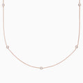 The Pave Rose 14K Rose Gold Diamond Station Necklace (0.62 TCW) features delicately bezel-set round diamonds, offering a minimal and elegant look against a plain white background.