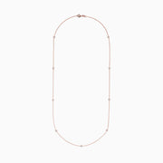 The Pave Rose 14K Rose Gold Diamond Station Necklace (0.62 TCW) features delicately bezel-set round diamonds, offering a minimal and elegant look against a plain white background.