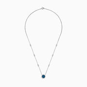 The Bella Bleu 14K White Gold White and Blue Diamond Stationary Necklace features a circular pendant with clustered blue diamonds surrounded by white diamonds, and a chain accented with additional sparkling white diamonds.