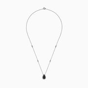 The 14K White Gold Black and White Diamond Pear Shaped Necklace, 1.09 TCW, features a teardrop pendant with black and white diamonds at the center, haloed by clear stones, plus two small clear stones set along the chain.