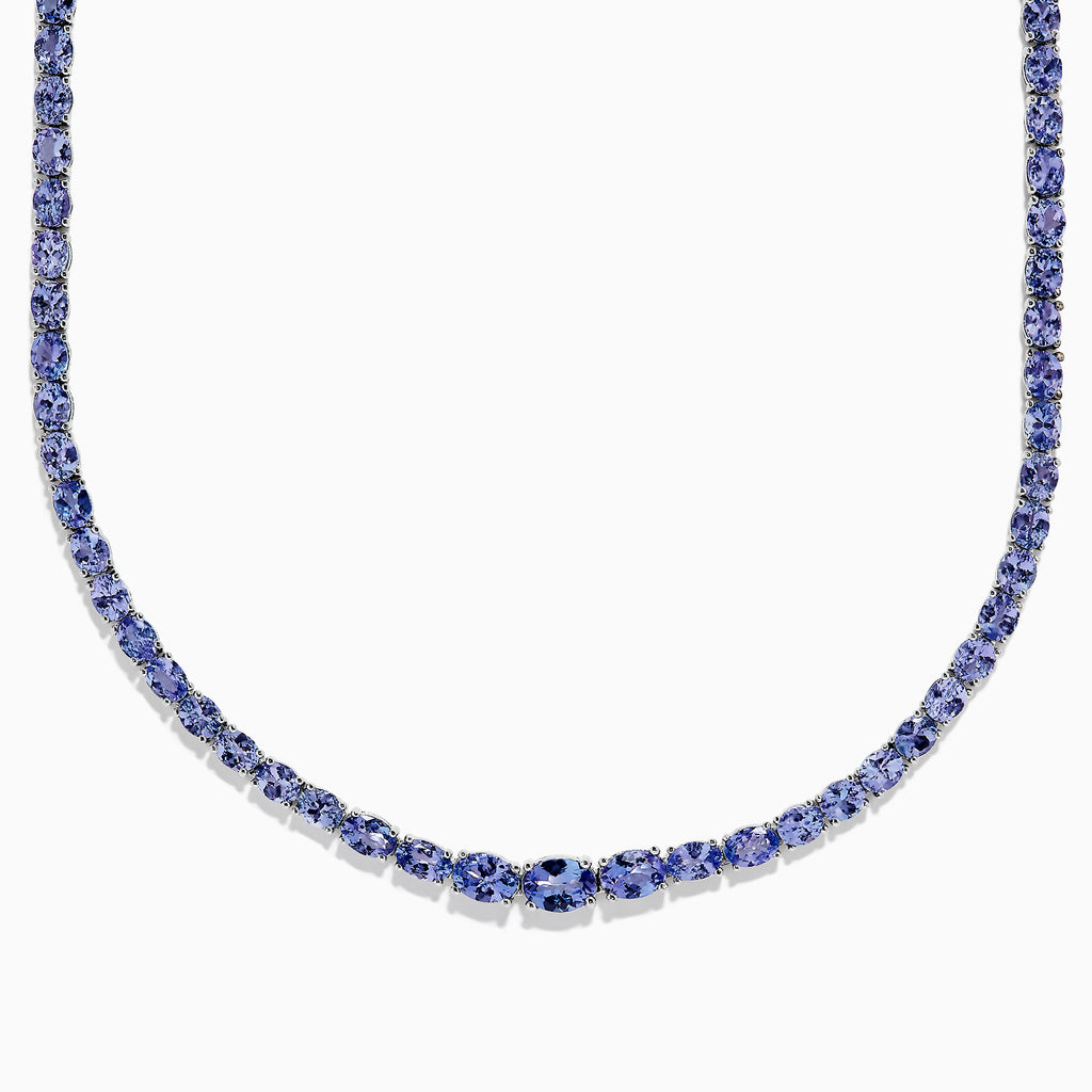 A close-up of the Nahla Siri Sterling Silver Tanzanite Necklace, 27.69 TCW, showcasing a continuous strand of round, faceted blue tanzanite gemstones set symmetrically against a white background.