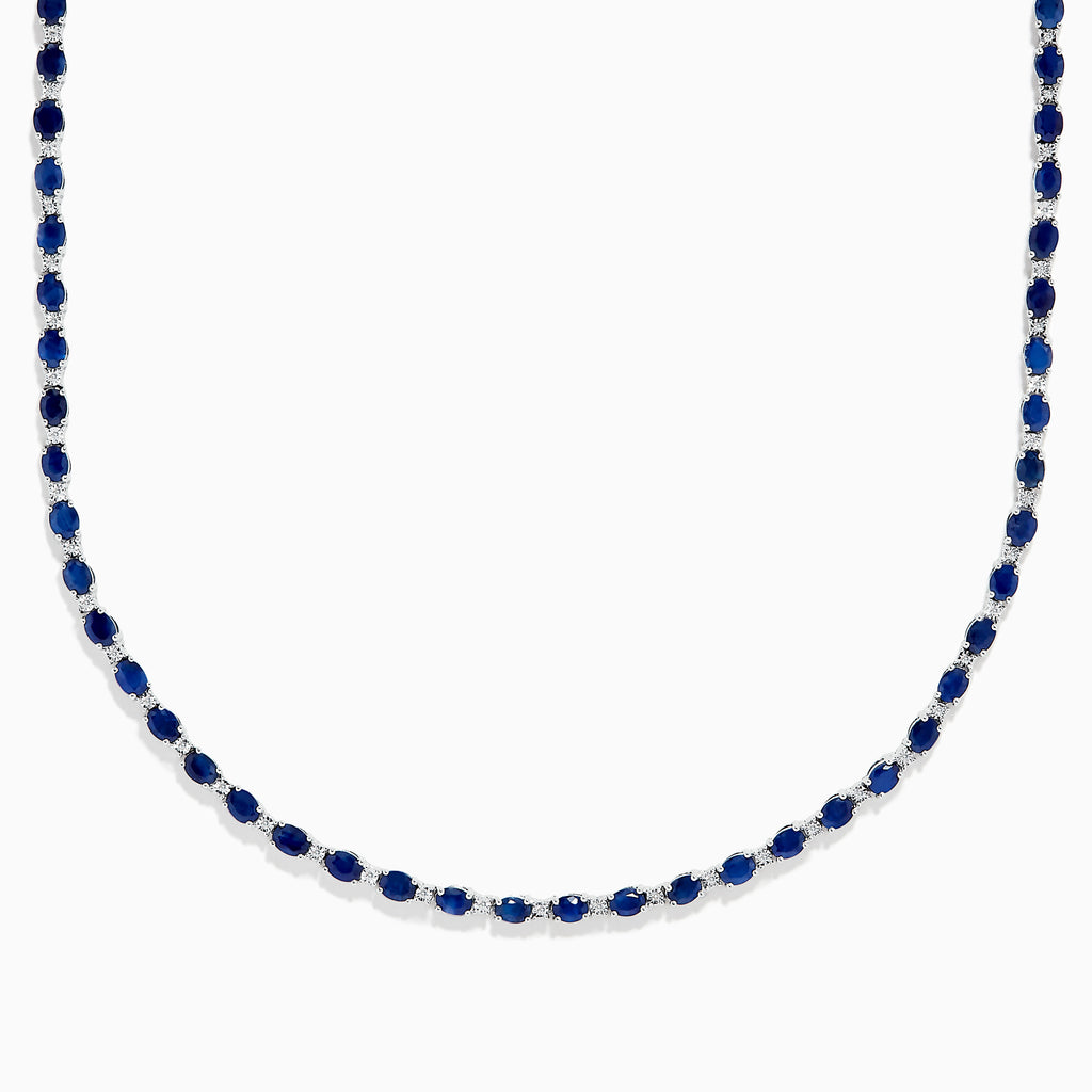 The 925 Sterling Silver Blue Sapphire Tennis Necklace features a continuous line of round blue sapphires set in sterling silver, creating a simple and elegant design.