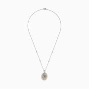 The Trio 14K Tri Color Gold Diamond Swirl Pendant, 1.28 TCW, features an intricate spiral of diamonds in three gold tones, gracefully suspended from a fine silver chain.