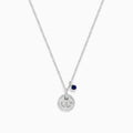 The Seaside Sterling Silver Sapphire and Diamond Anchor Necklace features a round, crystal-studded anchor pendant with a small dark blue sapphire charm, elegantly displayed on a white background.