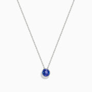 The 925 Sterling Silver Tanzanite Pendant features a delicate sterling silver chain with a tanzanite stone in a simple bezel setting, shown on a white background.