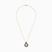 The Signature 14K Yellow Gold Diamond Spot Pendant features a circular design with black, gold, and white gemstones in a leopard print pattern. Its looped diamond detailing stands out beautifully against a plain white background.