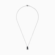 The Safari Sterling Silver Black and White Diamond Penguin Pendant (0.31 TCW) hangs from a delicate chain, its playful penguin design dazzling with black and white diamonds set in sterling silver against a white background.
