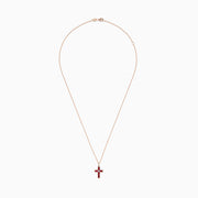 The Ruby Royale 14K Rose Gold Ruby and Diamond Cross Pendant, featuring a small clear center stone, is displayed on a rose gold chain against a white background.