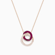 The Ruby Royale 14K Rose Gold Ruby and Diamond Intertwined Circles Pendant features two interlocking circles—one with rubies, one with diamonds—set against a white background, ideal for diamond jewelry lovers.
