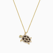 The Seaside 14K Gold Espresso & White Diamond Turtle Pendant (0.42 TCW) features a detailed jeweled shell, green eye, and turtle design on a chain necklace, with black, brown, and clear diamond accents.