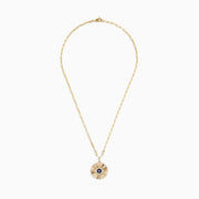 The Novelty 14K Yellow Gold Sapphire and Diamond Evil Eye Disk Pendant features a sunburst design with a sapphire center, diamond accents, gold spikes, and elongated oval chain links.