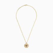 Nature 14K Yellow Gold Espresso and White Diamond Bee Coin Pendant: A yellow gold chain necklace with a round coin pendant featuring a white diamond bee, sparkling crystals, black accents, and a smooth ivory background.
