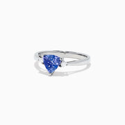 The Nahla Siri 14K White Gold Trillion Tanzanite and Diamond Ring, 1.07 TCW, features a triangular-cut tanzanite center accented by two round diamonds, shown on a white background.
