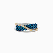 The 14K Two Tone Gold Blue and White Diamond Crossover Ring, 1.00 TCW, features a twisted silver design with yellow gold accents and sparkling rows of blue and white diamonds for a striking look.