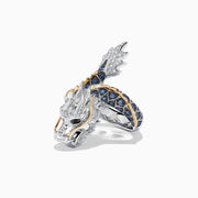 The Safari Sterling Silver and 14K Gold Sapphire Dragon Ring, 0.79 TCW, features a detailed dragon head and body with blue sapphires set along the band and gold accents on the scales, shown on a white background.